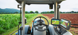 Autonomous agricultural machinery operating in a crop field using AI, sensors, and GPS navigation without a human driver.