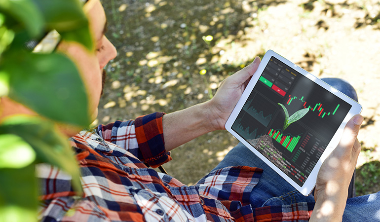 A farmer is monitoring his field using digital twin technology 