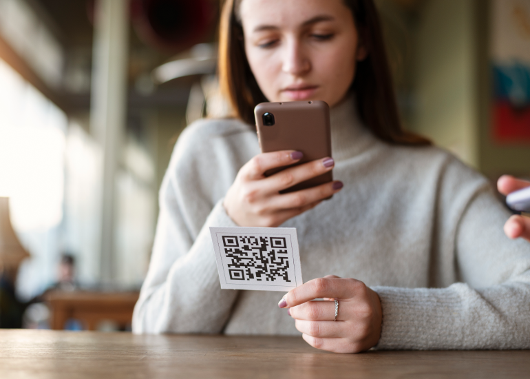 An image of someone using a smartphone to scan a QR code. 