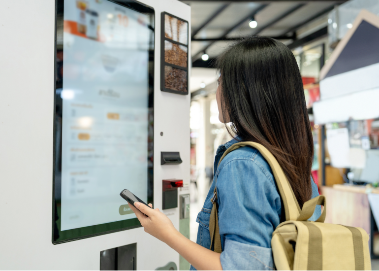 An image of a woman using a smart touchscreen device. 
