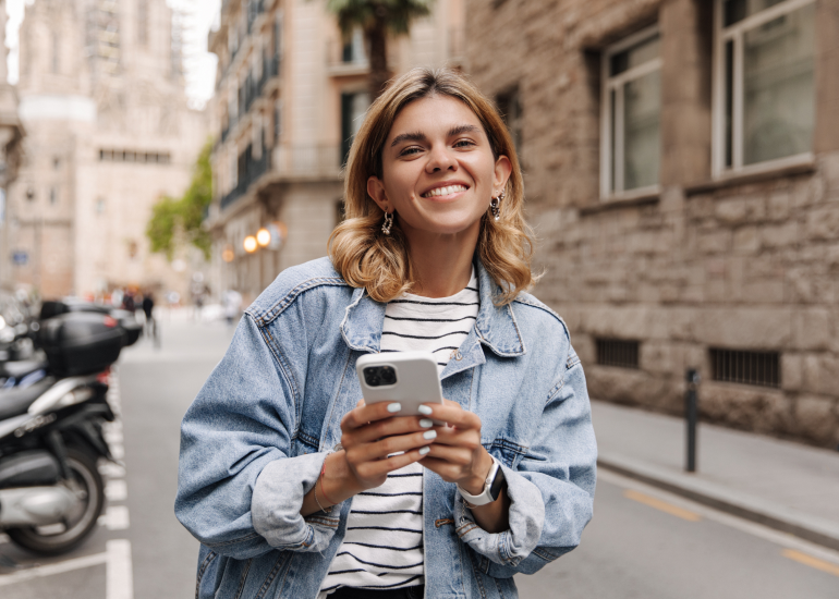 A woman using a smartphone for AI in travel 
