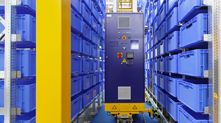 An automated storage and retrieval system (AR/RS) operating in a narrow warehouse aisle.